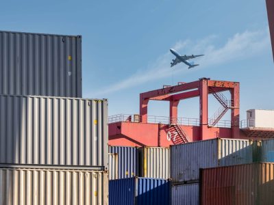 container-yard-closeup-with-airplane-in-sky-2025-01-29-07-38-20-utc.jpg